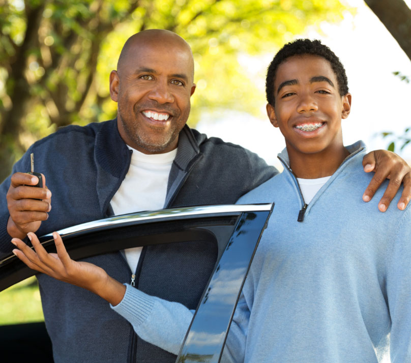 Father handing over the car keys to his 16-year-old son